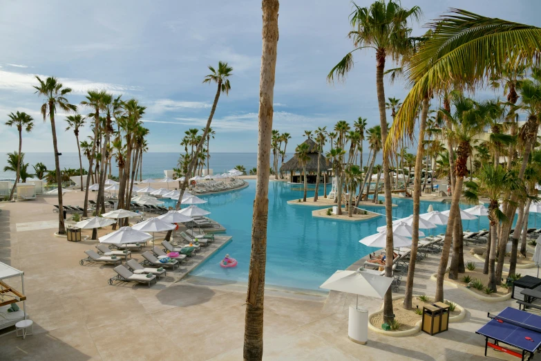 an ocean - side resort and beach resort with blue skies