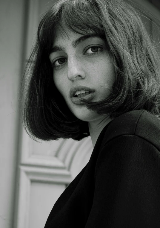 a girl with very long hair stares intently into the camera