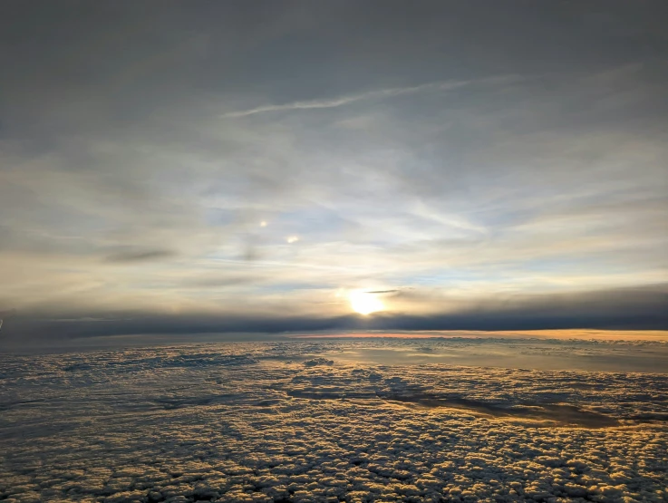 the sun is set on an ice covered beach