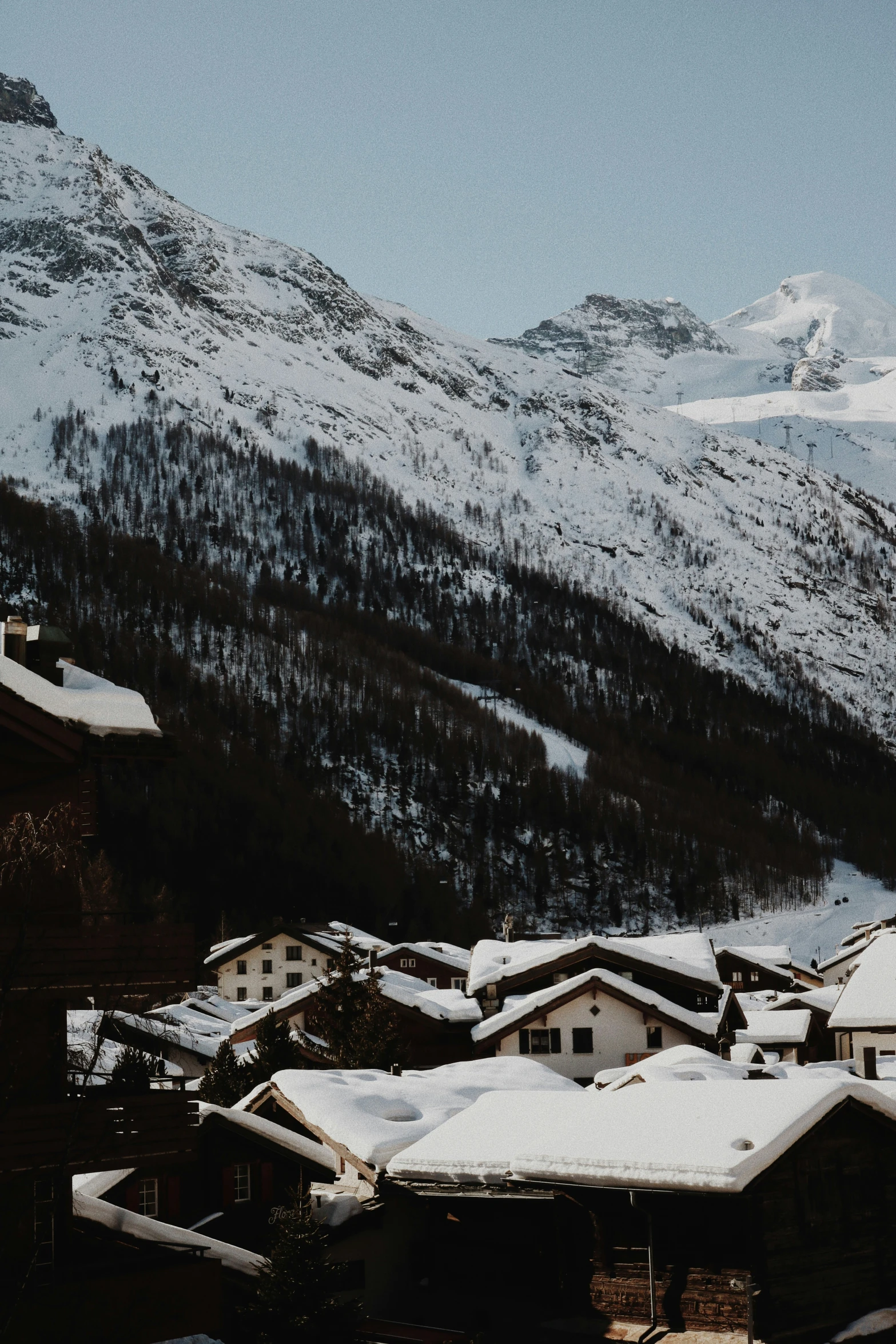 a view of a ski slope and buildings on top of the mountain