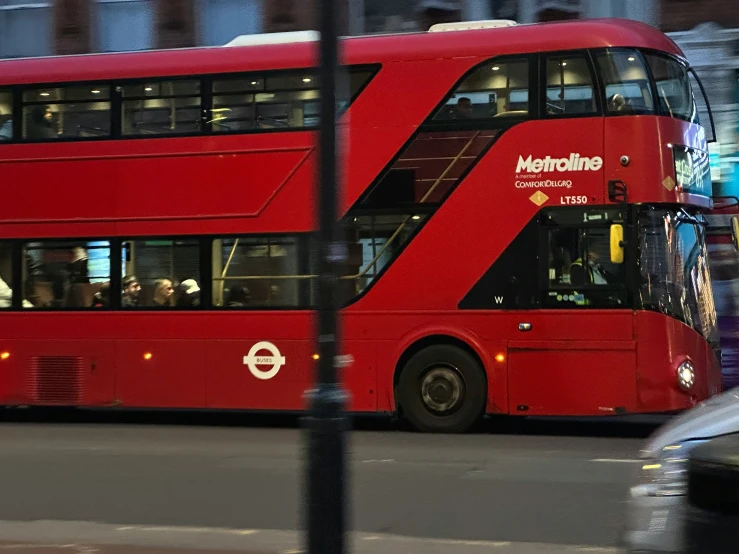 a double decker bus is traveling down the street