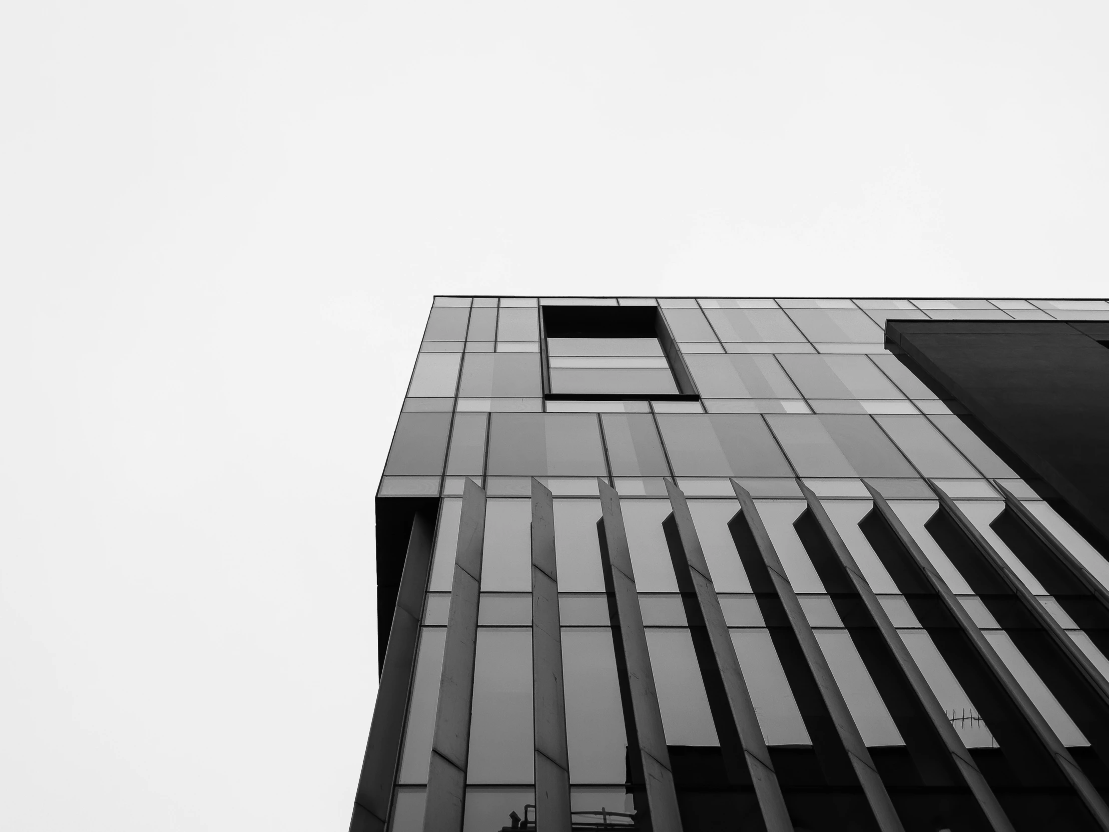 an airplane flies by a building with windows