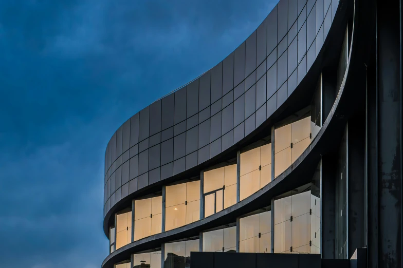 an artistic s of a building with a circular window and some light shining through it