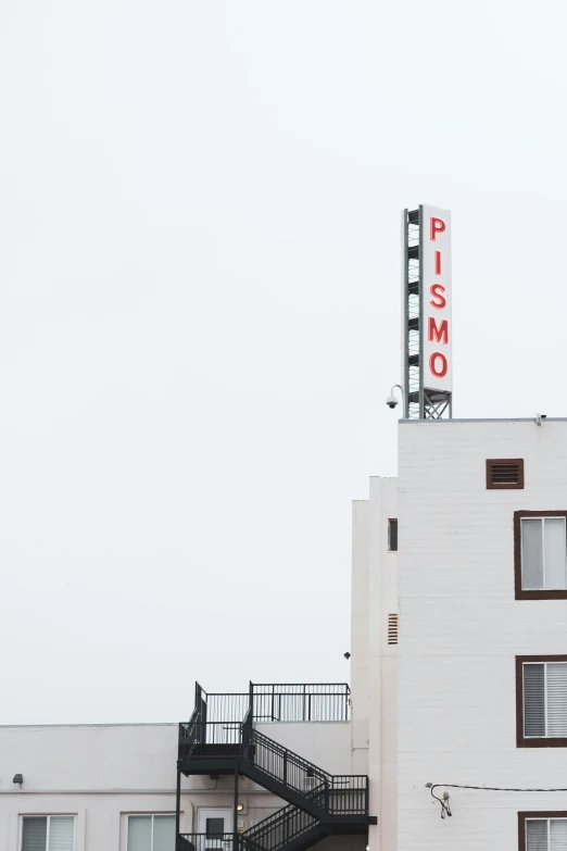 the view of a brick building with a metal stair going down it