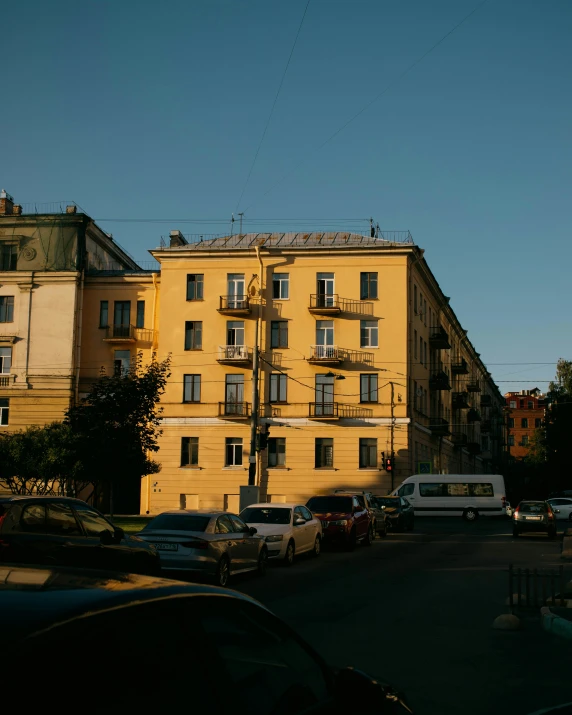 an old yellow building has lots of windows