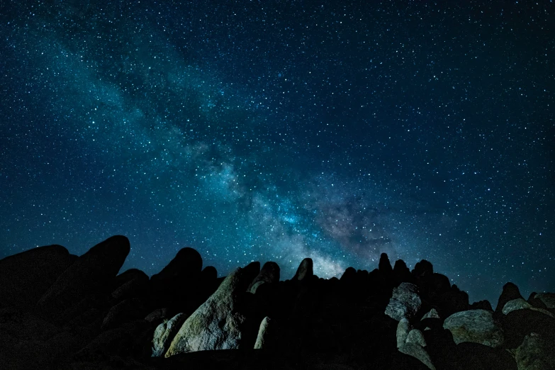 a rock formation with stars in the sky