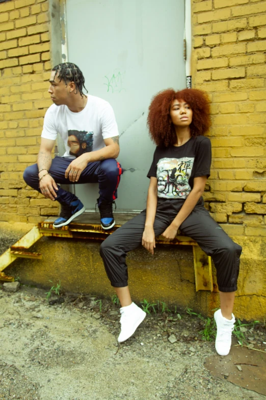 a man and woman sitting on a wooden bench next to each other