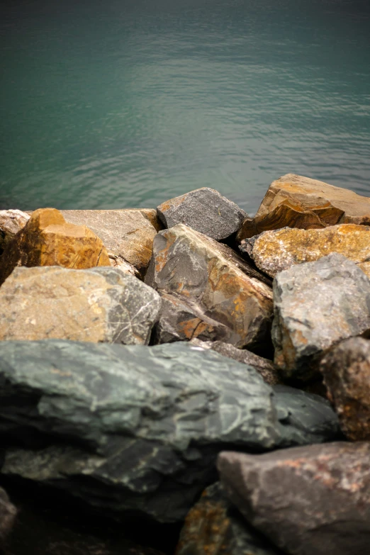 rocks sit in a rocky area near the water