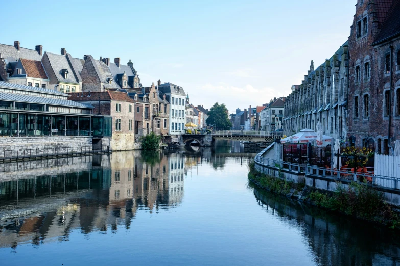 a beautiful, clear body of water next to old buildings