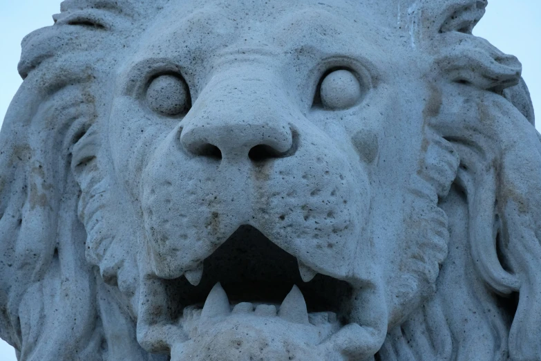 the stone head of a statue of a large lion