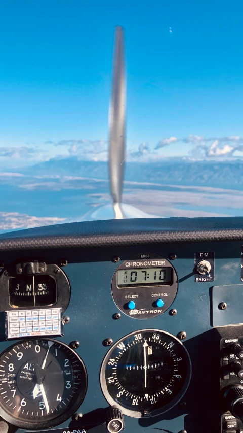 a airplane cockpit with two clock and gauges in the air