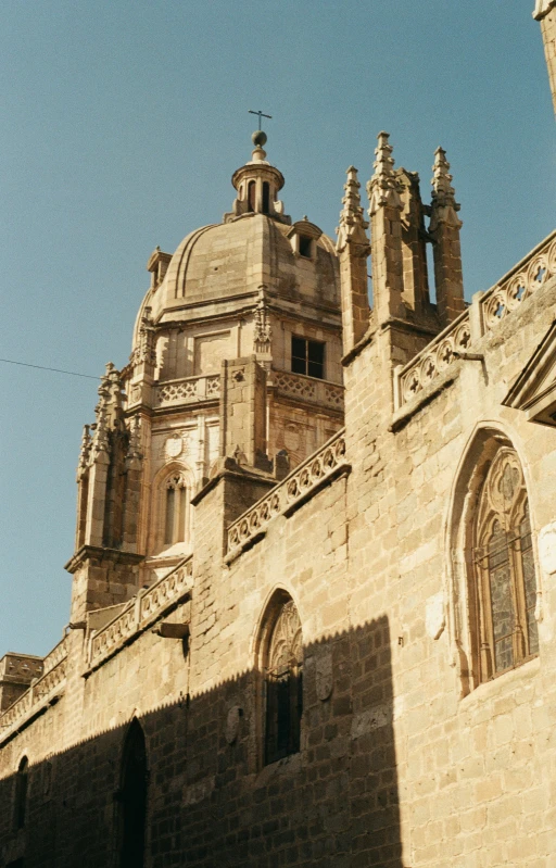 a tall building with windows and two steeple