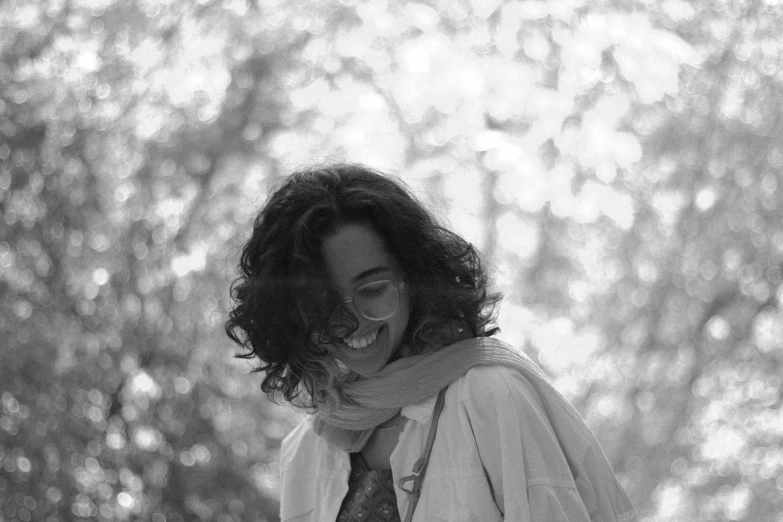 a smiling woman is wearing a tie and a white shirt