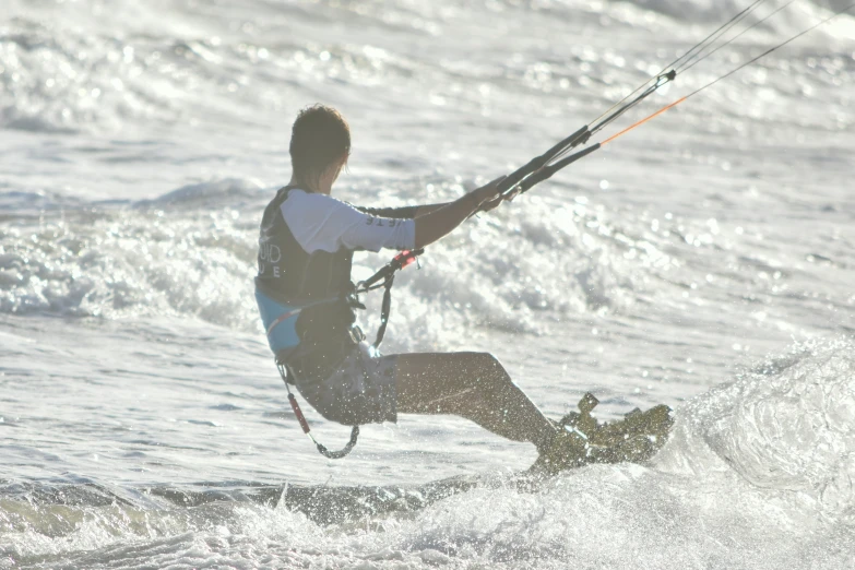 man in water suit with board on top of him doing water sport