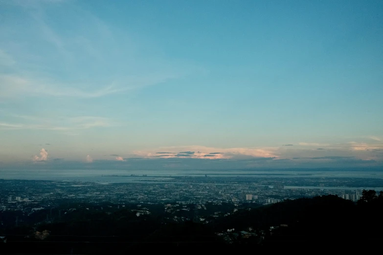 two benches on top of a hill overlooking the city