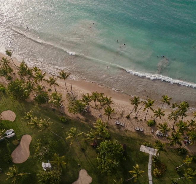 an aerial view of beach next to a body of water