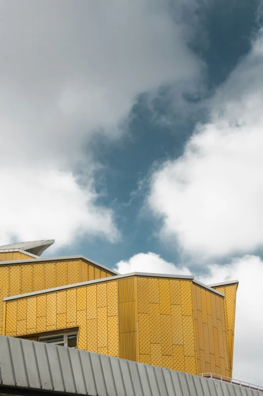 a yellow building with some metal roofs