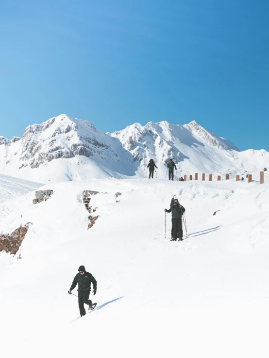 four snowboarders making their way down the slopes