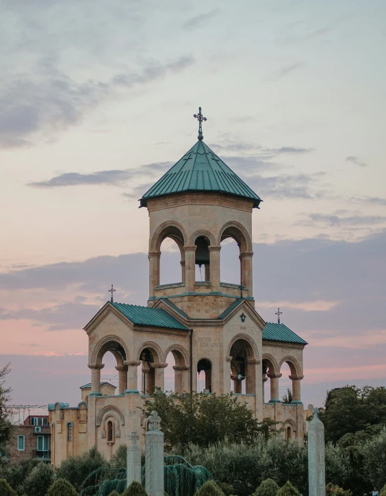 an old stone church with a green roof