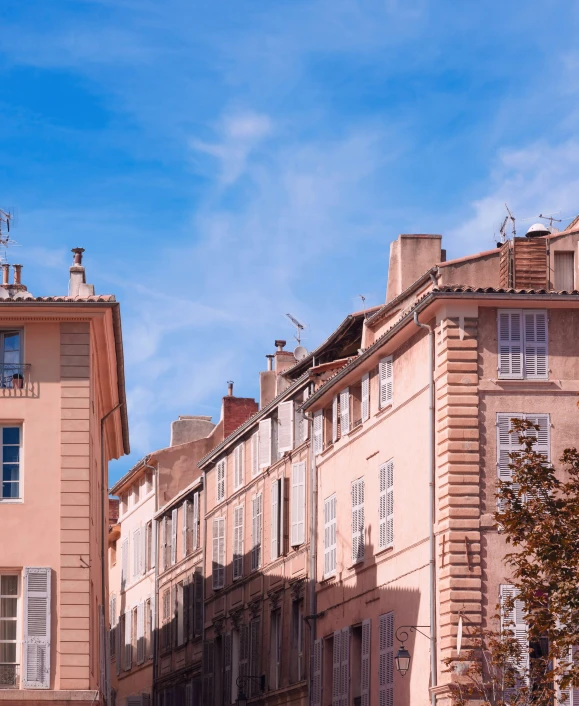 the side of three buildings with windows are facing each other