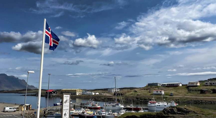 a flag flies in the wind in a marina