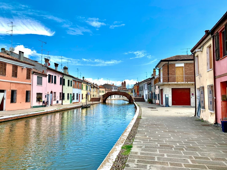 two boats are sitting in the water down the middle of a city street