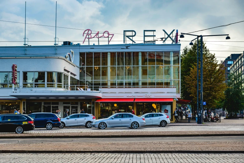 a red, white and blue building and some cars