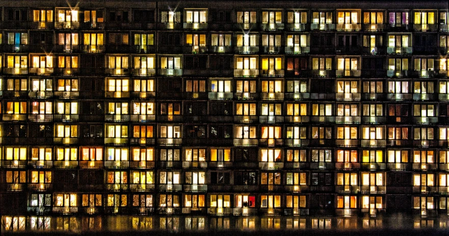 many windows in a very tall building at night
