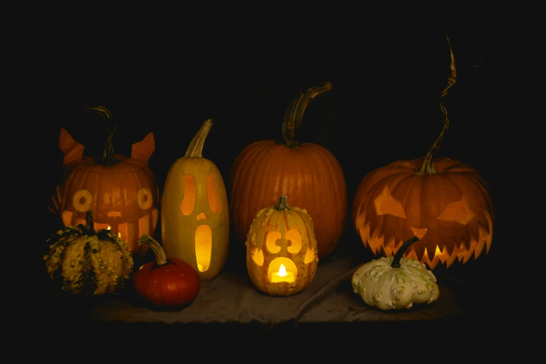 many carved pumpkins with eyes on them