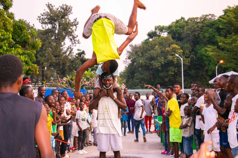 a  is balancing with a human in front of people