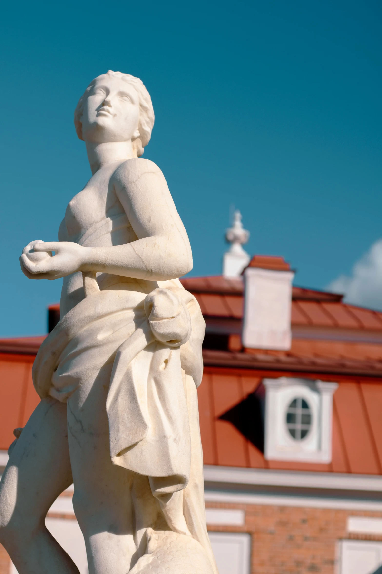 a statue stands in front of a building