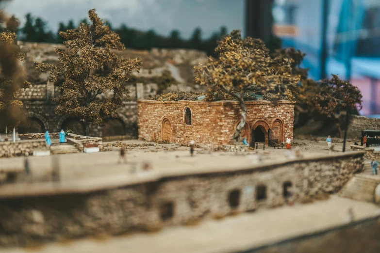 a model train station is shown with trees and buildings