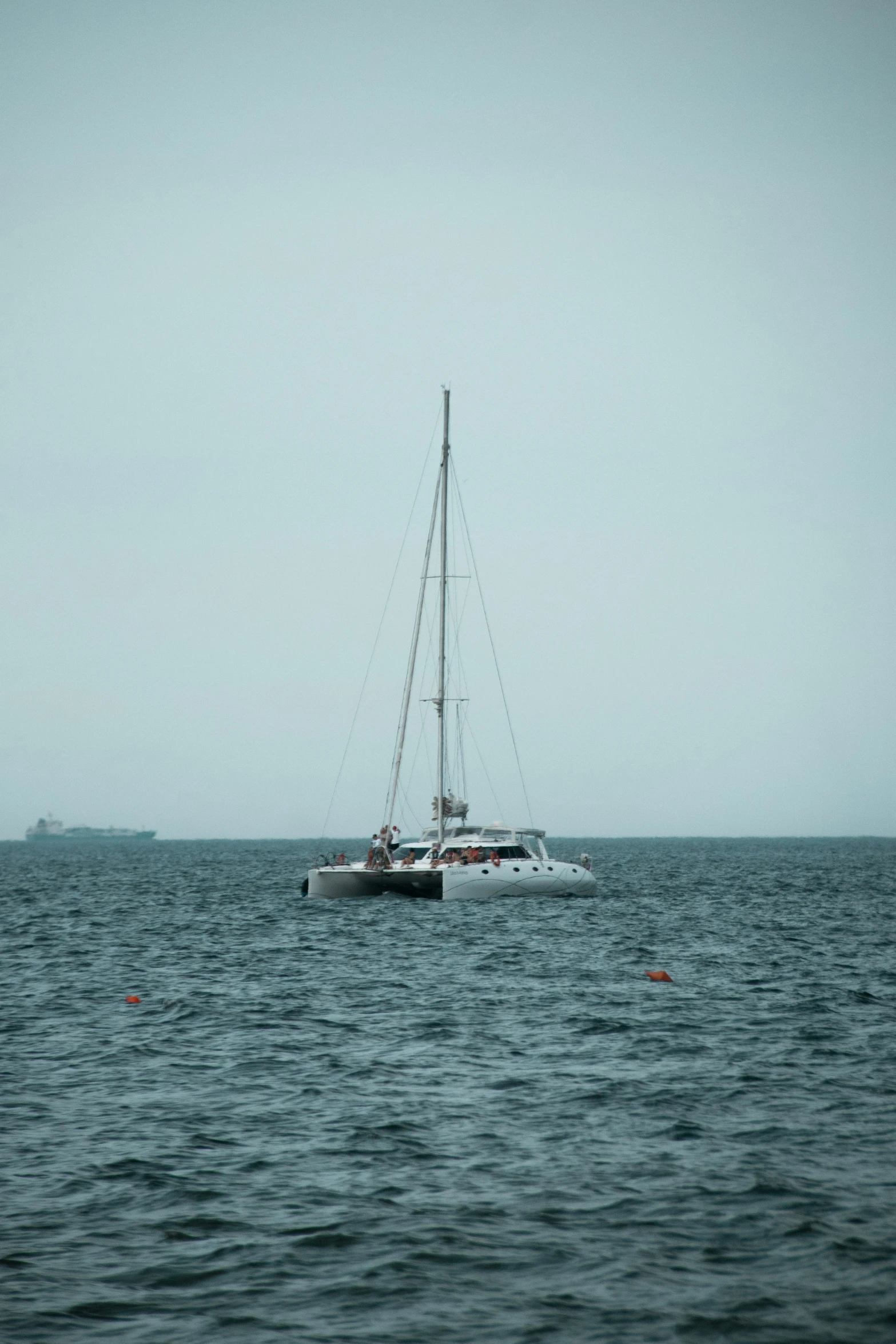 a sail boat with sails in the ocean