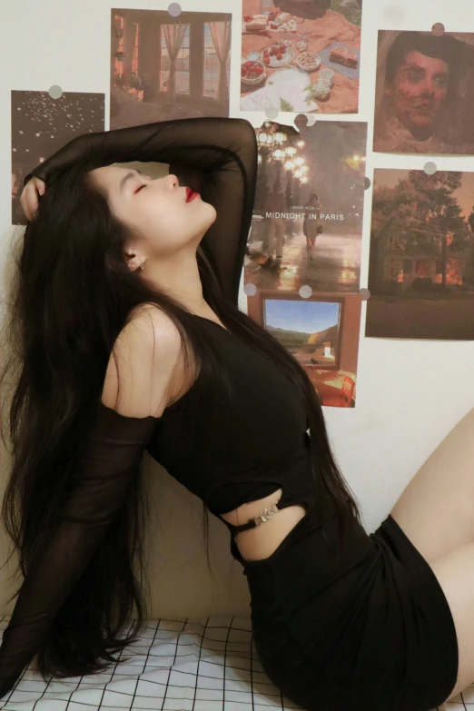 a young woman is posed in a black outfit