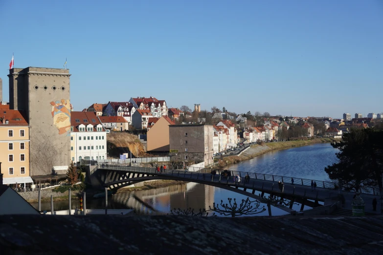 the bridge and buildings at the river side are reflecting in the water