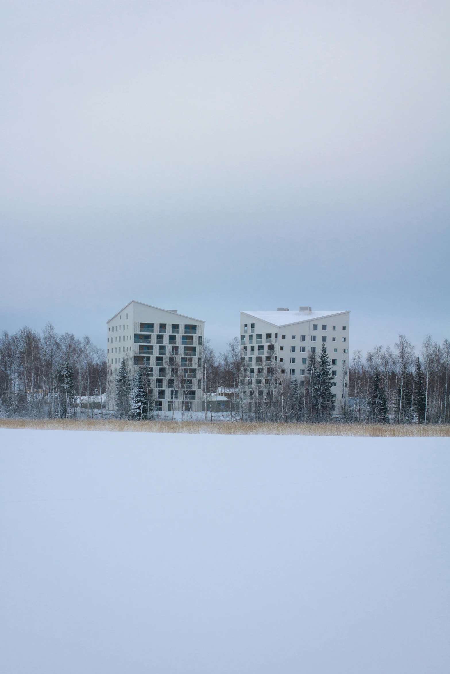 a building in the distance with snow on the ground