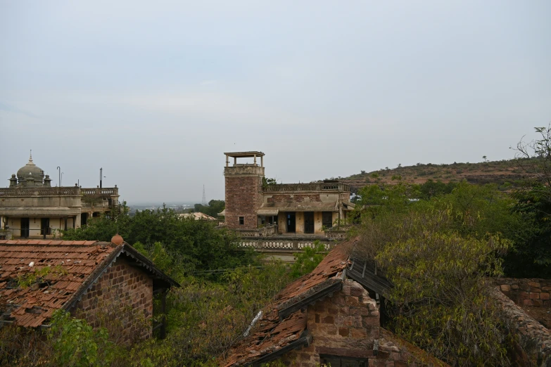 the old brick building is standing in the middle of the land