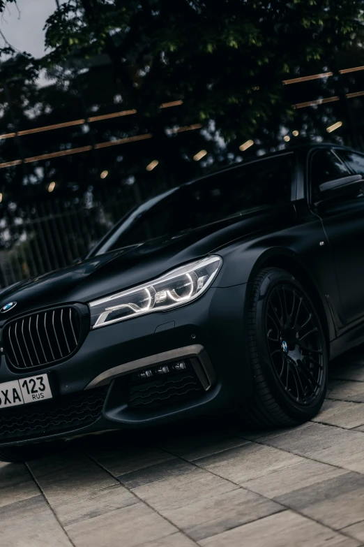 a black bmw vehicle parked outside of a building