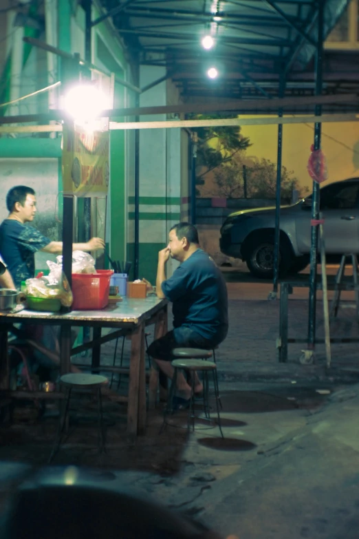 a couple sitting at a table in the dark