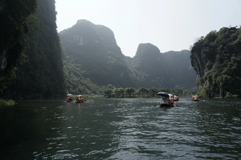 a group of people in canoes paddling on water