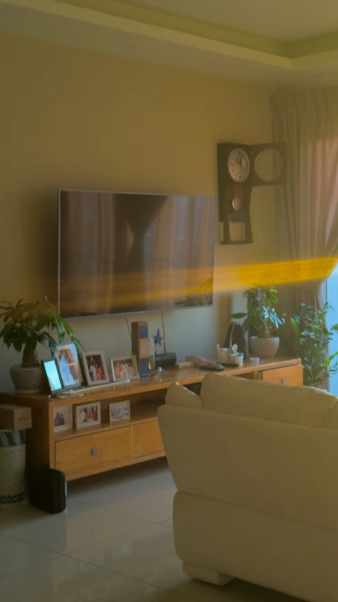 a living room with a white couch and a flat screen tv