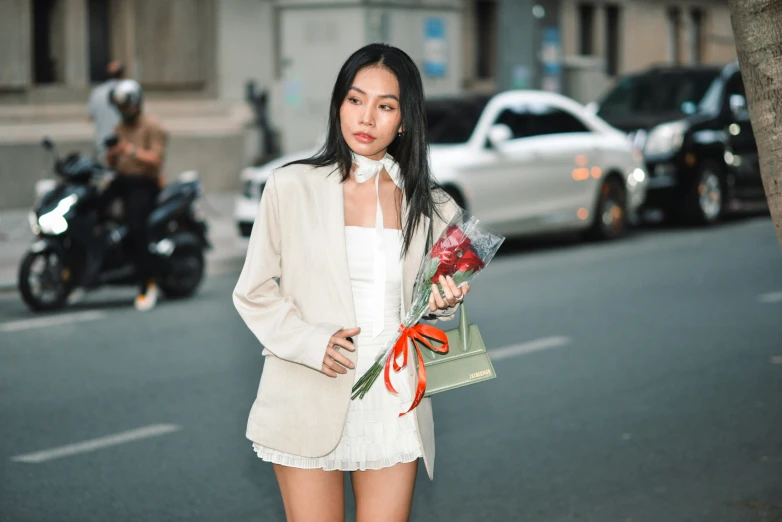 a young woman with long black hair holding flowers