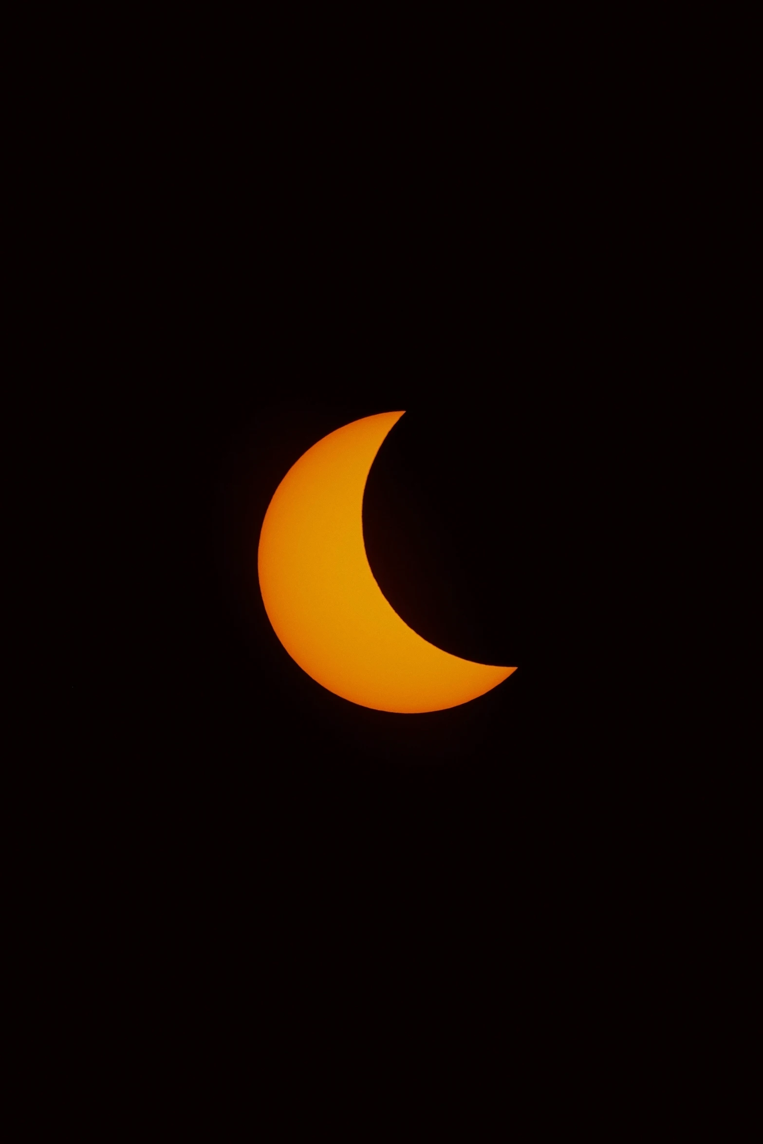 the moon partially covered by a partial solar eclipse