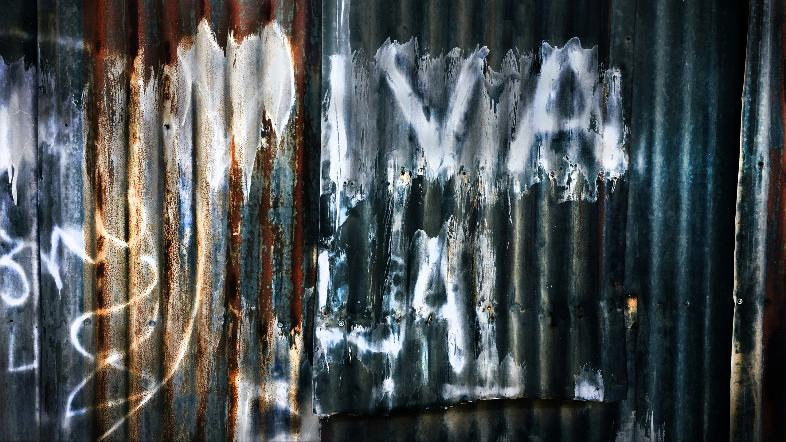 a wall with various graffiti written on it