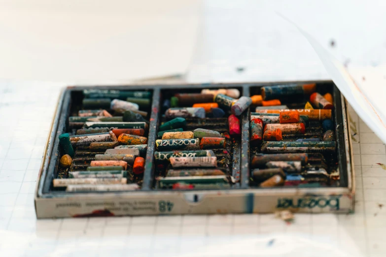 a close up of many pencils in a box