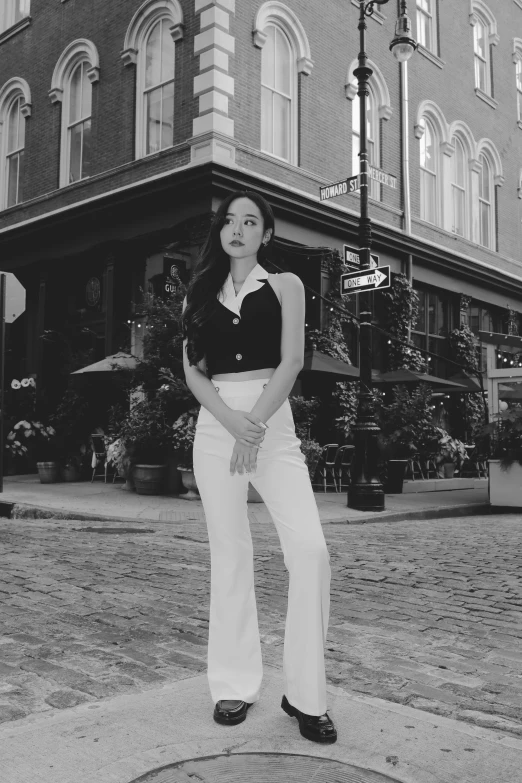 woman in black and white poses for the camera in front of the old town hall