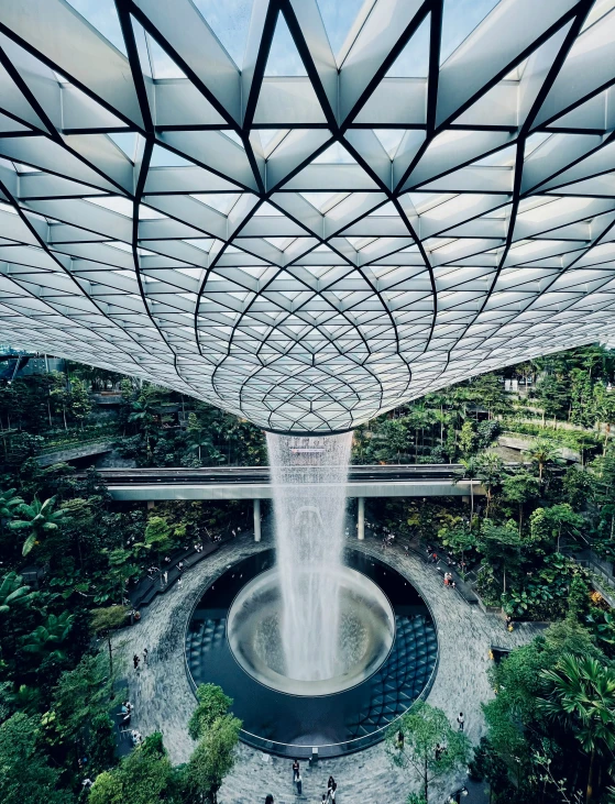 a large fountain is being held up by many trees