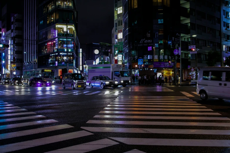 a city street with cars and people on the sidewalks