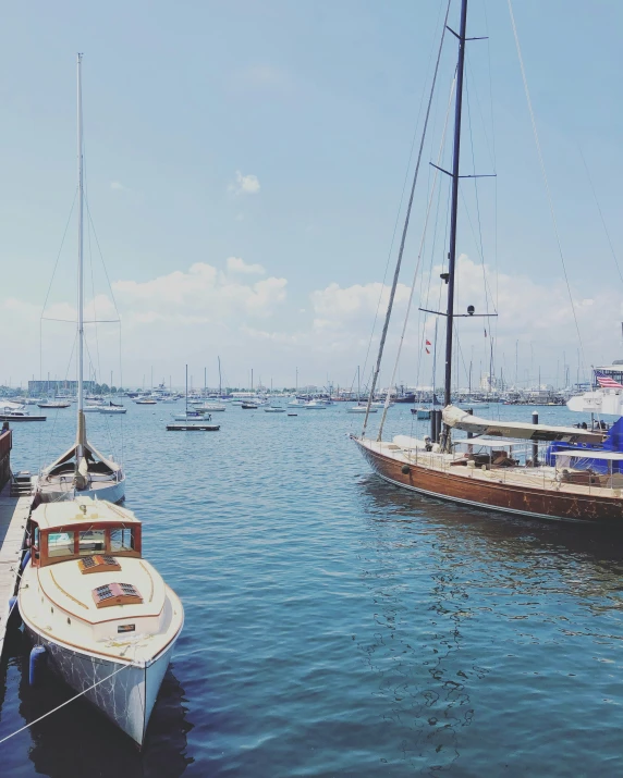 the boats are docked on the lake in the day time