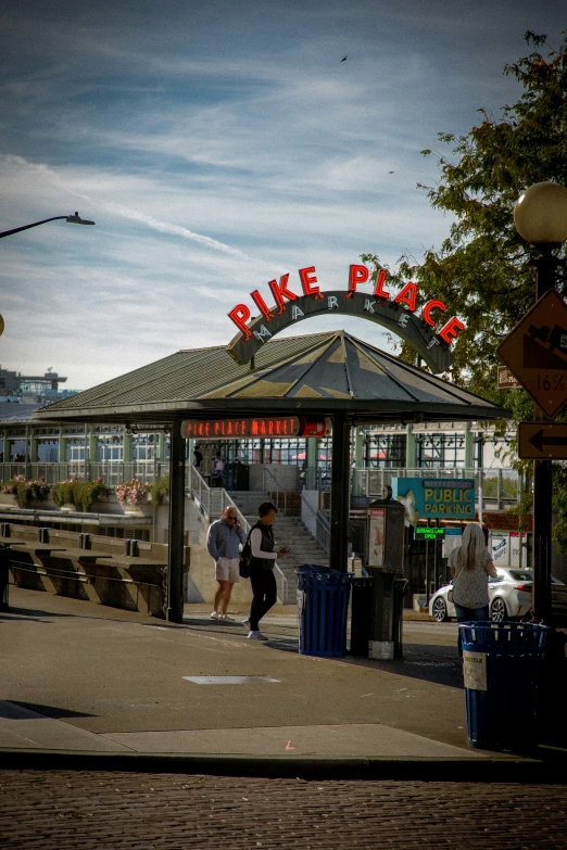 people walking on the sidewalk near a park